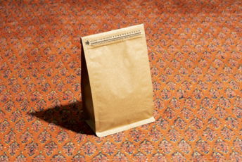 a-brown-paper-bag-sitting-on-top-of-a-carpet.jpg a brown paper bag sitting on top of a carpet